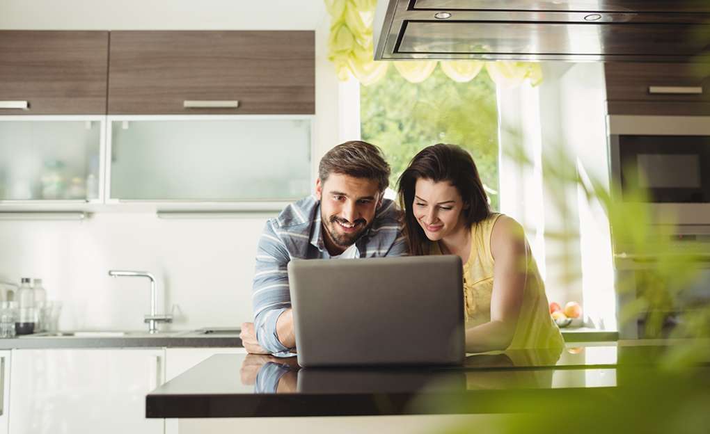 A couple looking at their laptop