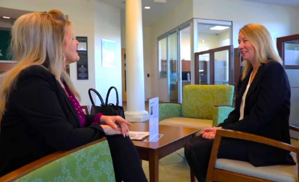 Two people have a conversation in the lobby of North Easton Savings Bank.