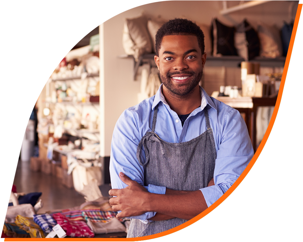 A fabric store employee stands proudly behind the counter.