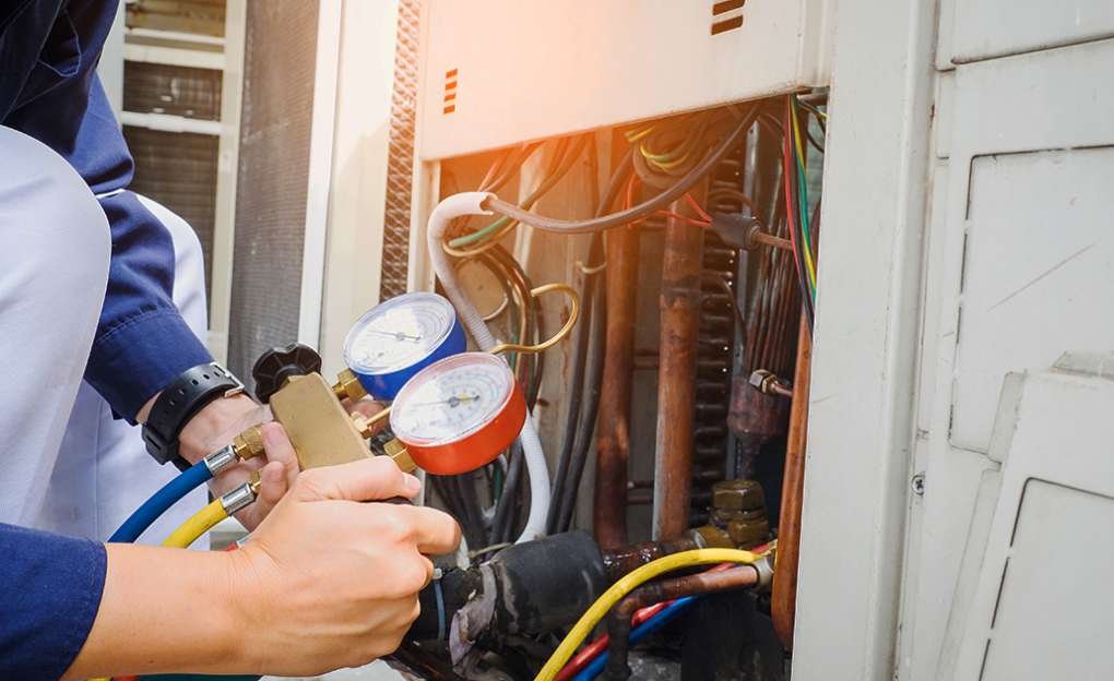 Worker checking pressure gauges on equipment