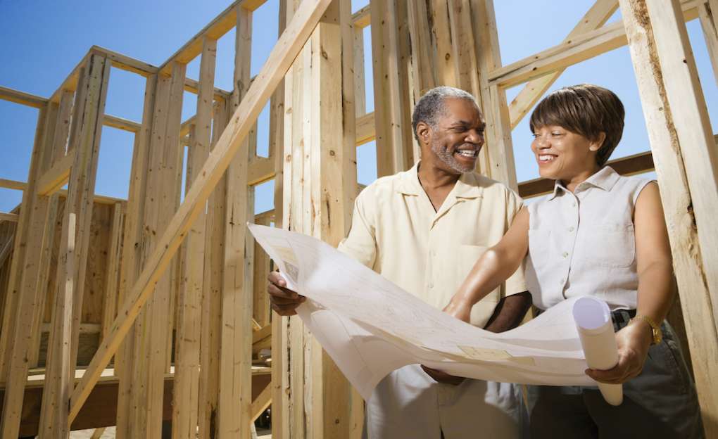 a couple looking over house construction plans