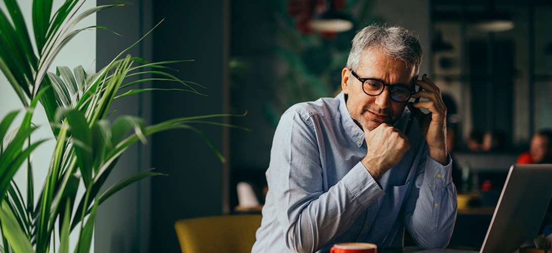 An older gentleman staring in space, deep in thought