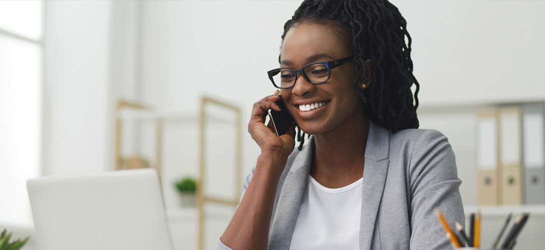 A young woman smiling while on the phone