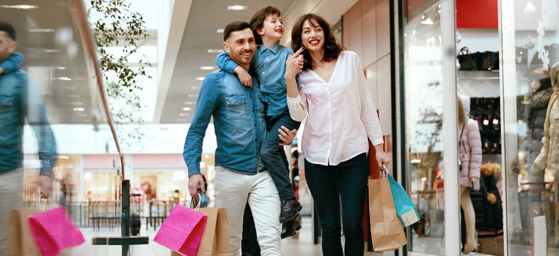 A young family shopping in a mall.
