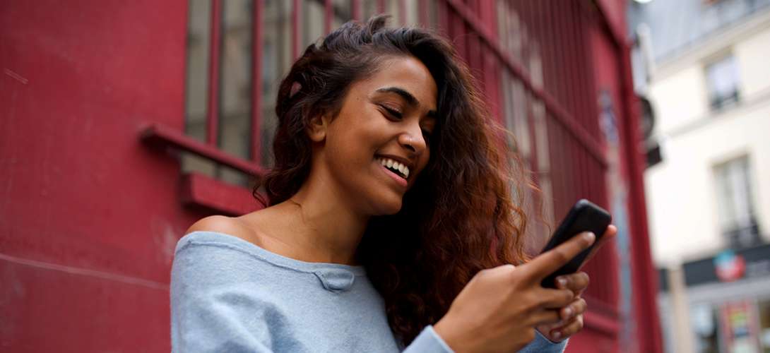 Young woman smiling at her phone