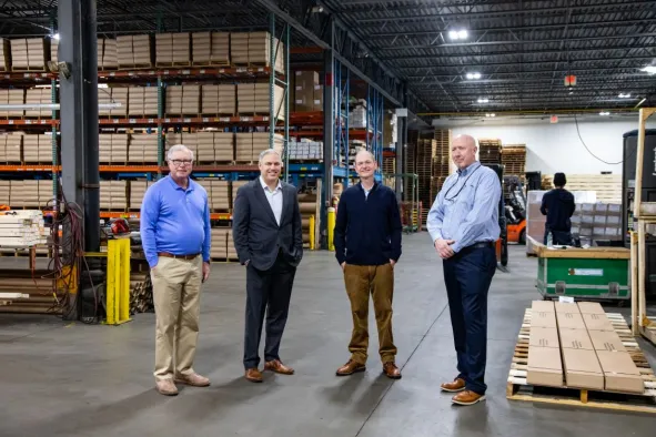 North Easton Savings Bank local business partners smiling in a warehouse