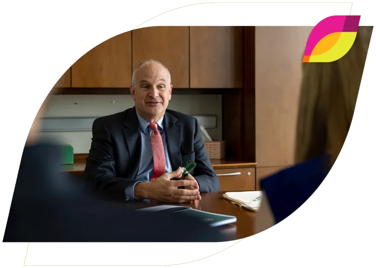 Bank lender sitting at a desk and talking to clients